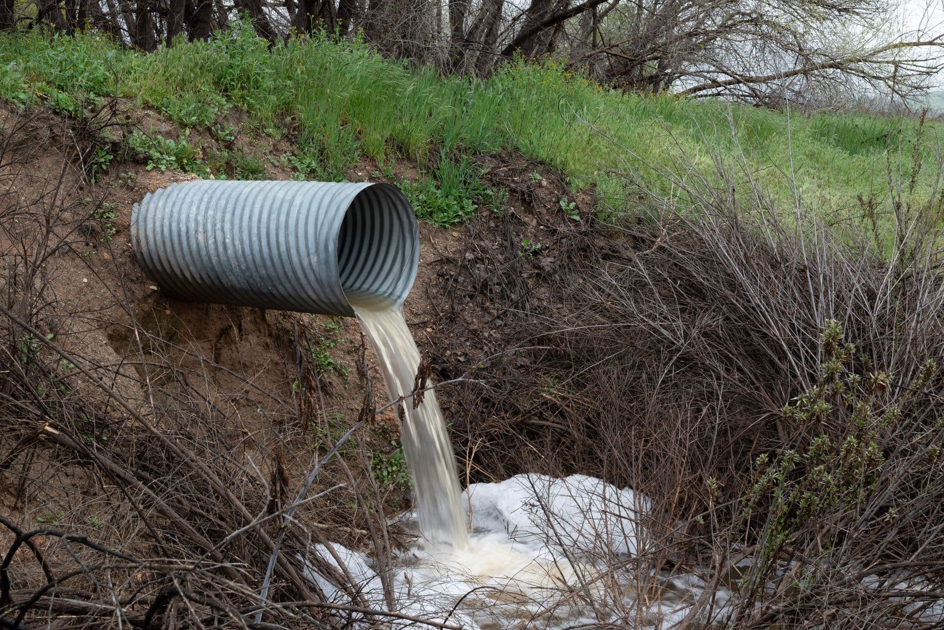 Water discharging cleanly from a drainage outlet away from a structure.
